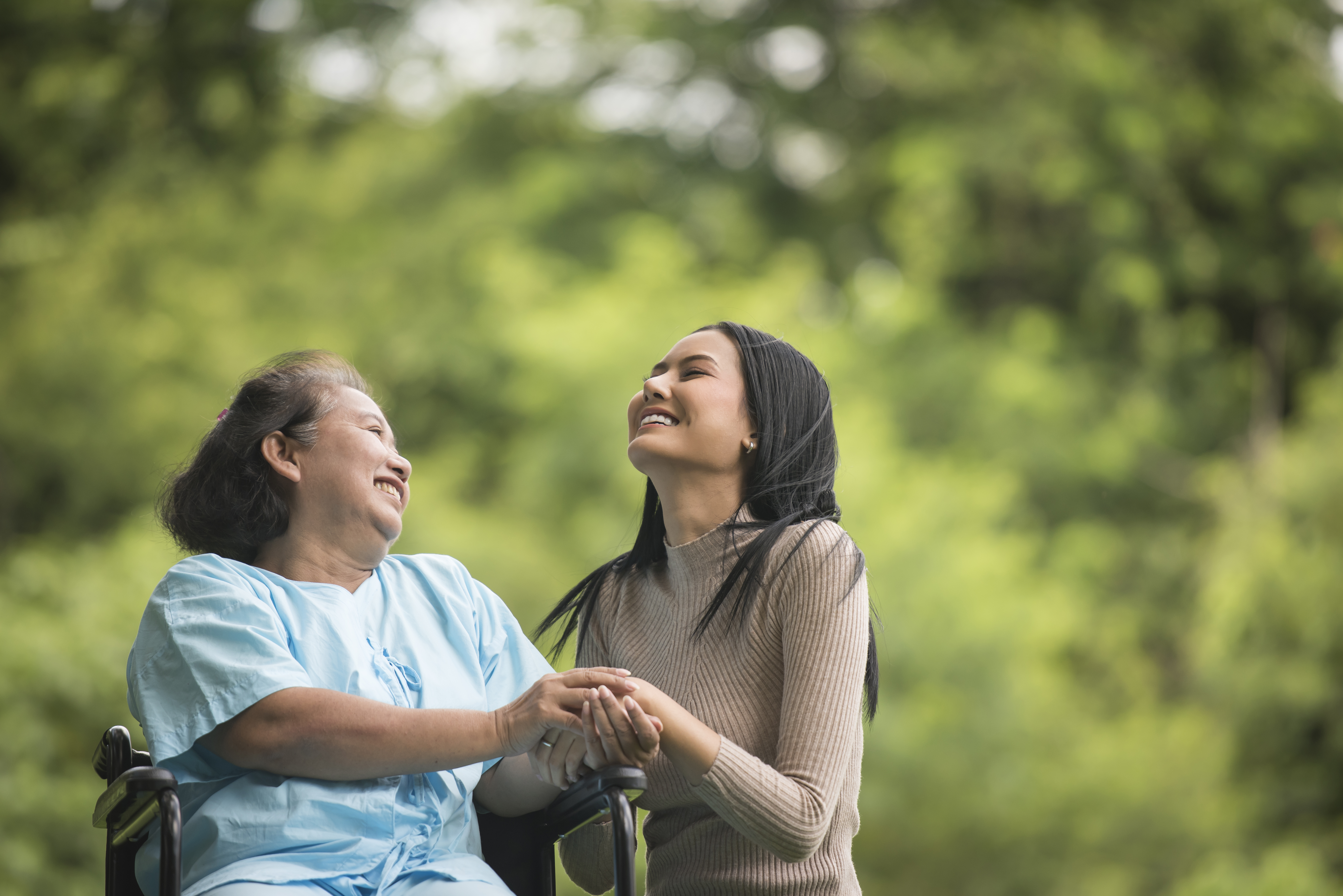 Caregiver sharing a happy moment with a senior client at home